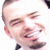 Two side-by-side pixelated faces: left face shows a smiling person with closed eyes and visible teeth, right face shows a person wearing a light-colored cap and dark clothing against a bright background.