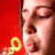 A person with closed eyes blows yellow bubble rings against a red background, transitioning from pursed lips to open mouth.