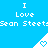 Blue background with repeated white text "I Love Sean Steet" and white triangular icons containing light blue hearts.