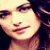 A pixelated close-up of a person's face with dark hair, light skin tone, and closed eyes under warm lighting.