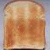 A single slice of toasted bread with uneven browning on a light blue background.