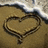 A beach scene with a heart drawn in sand, waves at the top, and four text blocks arranged around it.