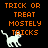 Pixelated orange text on black background with white cat icon, displaying 'TRICK OR TREAT MOSTELY TRICKS' in three stacked lines.