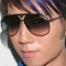repeated images showing a person with dark sunglasses and striped hair, featuring animated purple text elements appearing in different positions across frames