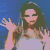 A woman with long dark hair and sunglasses wears a light-colored sleeveless top against a blue background, her hands raised in two distinct poses.