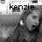 Black-and-white image of a person with long hair and an earpiece, text 'kenzie' overlaid in dark letters across the top.