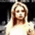 A pixelated image of a person with long blonde hair wearing a white top and dark shorts, holding a white object against a dark background.