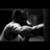 Pixelated grayscale image of a figure in dynamic pose with extended arm, set against dark background.