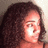 Pixelated image of a person with curly hair and pink text reading 'charlie' on the right side.