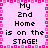 Pixelated text on a pink background with a pixelated border, displaying 'My 2nd Home is on the STAGE!' in black and white.