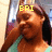 Pixelated image of a person with long brown hair wearing a green tie, holding an object near their face, with yellow text 'ERI' overlaid on the forehead.
