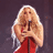 Britney Spears in red dress singing into microphone, two distinct stage lighting backgrounds with text 'Shaking' on right