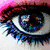 A pixelated eye with blue and purple hues, a rainbow-colored butterfly on black background, and a red 'U' on a multicolored striped backdrop.
