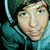 Pixelated image of a person in teal hoodie with dark hood, next to stylized text and pixel hearts.