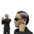 Animated sequence of a person in black clothing holding a small object, with side profile views showing hand near ear and head turning left to right.