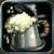 A pixelated static image shows a light-colored mug with a handle on the right side, filled with a frothy substance against a dark background.