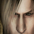 A pixelated split image shows a close-up of a person's face on the left and a metallic weapon on the right against black background.