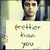 Pixelated static image of a person holding a sign with handwritten text, set against an indistinct background.