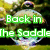 Green text reads 'Back in The Saddle a bubble' over a blurred background with a central circular shape.