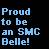 Static pixelated image with light blue text on dark background reading 'Proud to be an SMC Belle!' in blocky font.