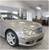 Pixelated static image of a silver sedan with visible front wheel, headlights, and grille, set against a blurred background.