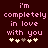 Pixelated text reads "i'm completely in love with you" in pink on dark red background with four heart symbols below.