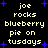 Pixelated text on black background with blue stars, displaying 'joe rocks blueberry pie on tuesdays' in two identical vertical