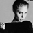 Black-and-white pixelated static image of a person with short dark hair wearing a black top against a light gray background, rendered in low-resolution 48x48 pixels with visible dithering and blocky artifacts.