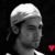 A black-and-white image of a person wearing a white headwrap, with four red heart symbols positioned around the frame.