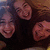 Group of people with long brown hair smiling, one frame shows blue text overlay.