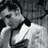 Static grayscale buddy icon of a person with dark hair and light clothing, rendered in low-resolution pixel art style against a dark background.