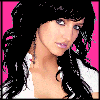 Pixelated image of a person with long dark hair against pink background, wearing white top and earrings.