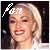 A pixelated image of a person with blonde hair and red lipstick, showing two states: one with white text-like symbols on the forehead and another with black symbols.