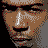 A static contact sheet of a 4x4 grid showing the same pixelated image across all frames, featuring red text "JARULE" and "Ja Rule THE INC", with partial face on left, website URL at bottom, and gray background.
