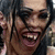Pixelated image of a person with dark hair and visible teeth, next to text reading 'At least I don't look like her' on black background.