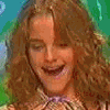 A four- shows a person with long wavy brown hair in different poses against green and blue backgrounds, holding a pink object