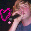 A four- shows a person with light brown hair in various poses: singing into a microphone, wearing a blue knit beanie, and smiling. Pink heart outlines and stars decorate the