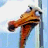 Pixelated cartoon fish head with orange-brown body and white eye against light blue background, next to black pixelated text on cyan background reading "fish gotta swim... birds gotta eat".
