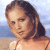 Pixelated image of a person with brown hair in a side ponytail against a beach background, next to green text reading 'Original Icons .com' on dark green.
