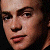 Pixelated close-up of a person's face on left, green background with pixelated text 'Original Icons .com' on right.