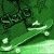 Green-toned static image with abstract shapes and light streaks against a pixelated background.