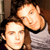Static 50x50 pixel icon showing two human faces in close proximity with one person's head resting on the other's shoulder, rendered in low-resolution pixel art style with warm color tones and visible dithering.