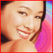six pixelated images shows a person with dark hair in various poses against colorful backgrounds, some wearing earrings and wristwatches