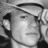 Black-and-white animated icon of a person wearing a cap, with visible eye and mouth details
