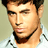 Pixelated static image of a man's face with dark hair and light skin, wearing a white shirt against a neutral background.