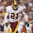 Pixelated image of a football player in white uniform with number 21, divided into four quadrants with red and gray sections containing yellow text.