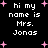 Black background with white pixelated text reading "hi my name is Mrs. Jonas" and pink plus-shaped stars scattered throughout.