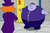 Two pixelated cartoon characters stand side-by-side; one wears a purple top hat and coat with orange hair, the other is round in dark blue clothing with white accents.