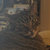 Pixelated static image with indistinct shapes and muted colors including gray, brown, and beige tones.