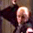 Pixelated animated contact sheet showing two frames of a character with light hair in dark clothing against warm-toned background, likely from an old movie or cartoon series.